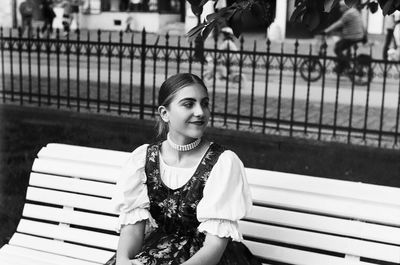 Portrait of smiling woman sitting on bench