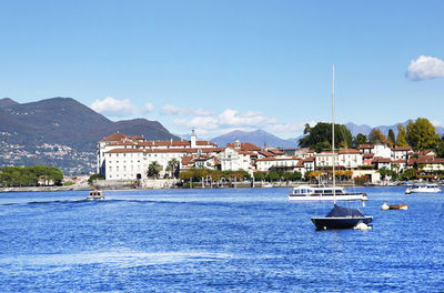 Sailboats in sea against blue sky