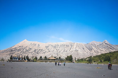 Group of people against mountains and blue sky