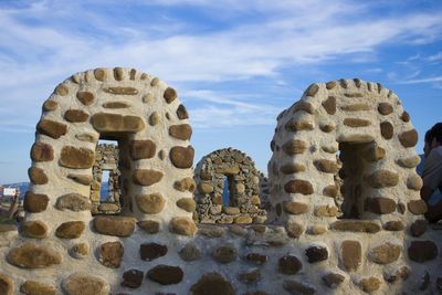 Ancient structure against cloudy sky