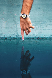 Low section of man with reflection in water