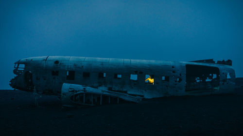 Abandoned airplane against clear blue sky