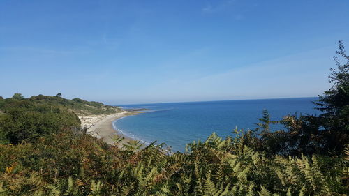 Scenic view of sea against blue sky