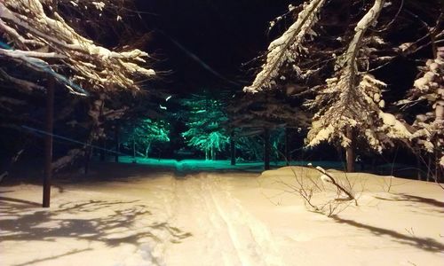 Scenic view of snow covered land at night