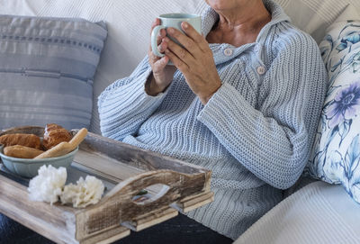 High angle view of woman sitting on table at home