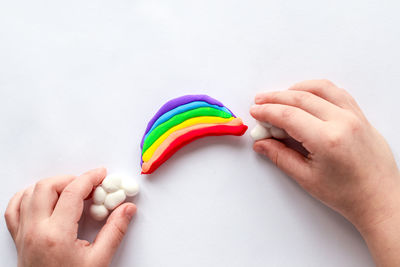 The child sculpts a rainbow and clouds from plasticine. children's creativity.