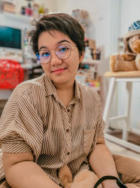 Portrait of young woman sitting at home