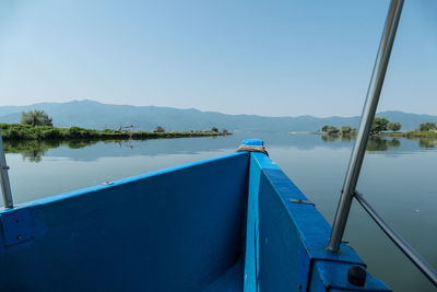 Scenic view of lake against clear blue sky