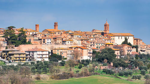 Buildings in town against clear blue sky