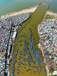 High angle view of sea by buildings in city