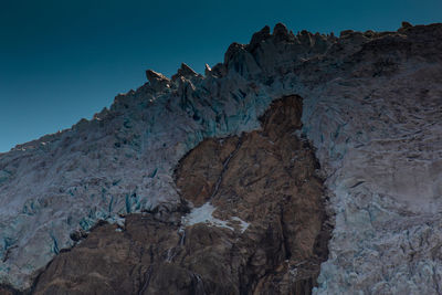 Low angle view of rock formation against sky