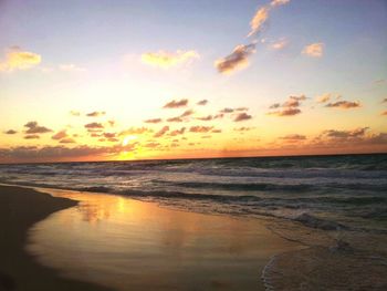 Scenic view of beach against sky during sunset