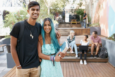 Portrait of smiling friends sitting at restaurant