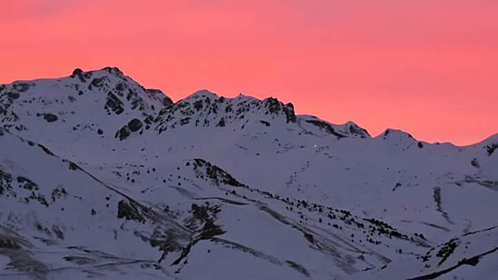 SCENIC VIEW OF MOUNTAINS AGAINST SUNSET