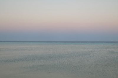 Scenic view of sea against clear sky during sunset