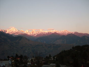 Scenic view of snowcapped mountains against sky at dusk