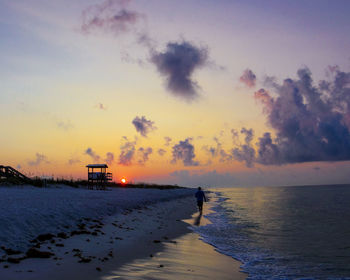 Scenic view of beach against sky during sunset