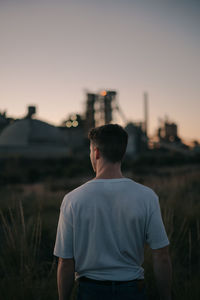 Rear view of man looking at sunset