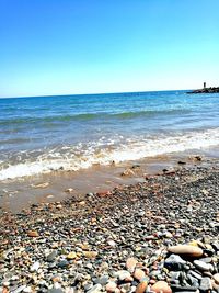 Scenic view of beach against clear sky