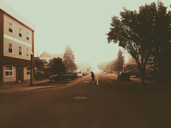 Street amidst buildings against sky in city