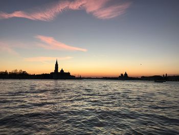 Silhouette of building against sky during sunset