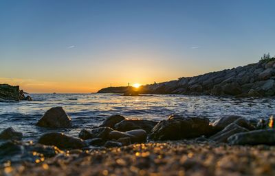 Scenic view of sea against clear sky during sunset