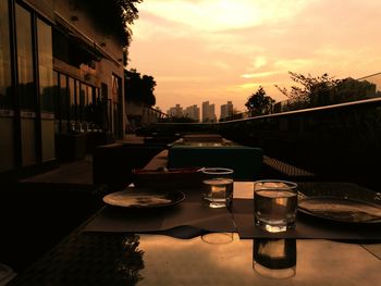 Built structures against sky at sunset