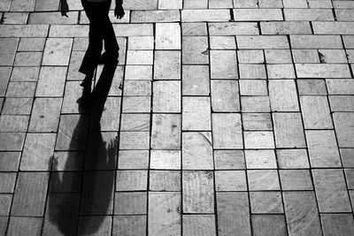 Low section of person walking on footpath