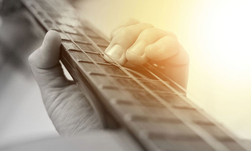 Close-up of hands playing guitar
