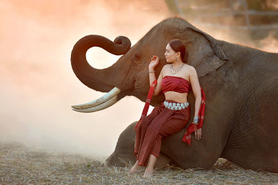 Full length of young woman on field