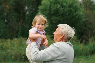 Side view of mother and daughter in park