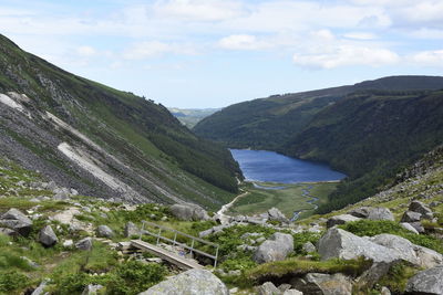 Scenic view of river amidst mountains against sky