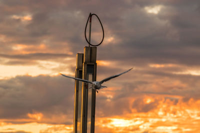 Close-up of silhouette tower against sky during sunset