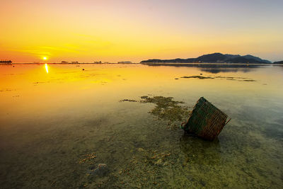 Scenic view of sea against sky at sunset