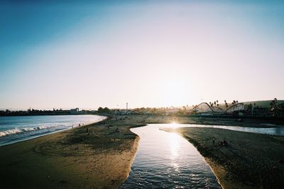 Scenic view of river against clear sky at sunset