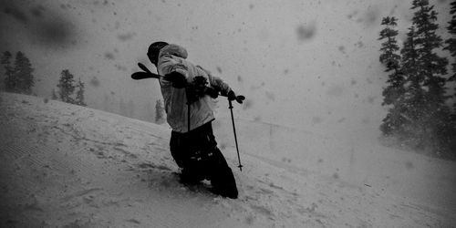 Person holding umbrella in snow