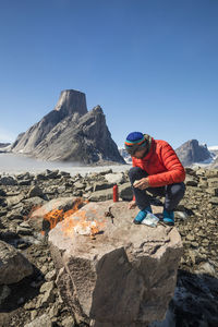 Mountaineer bunrs toilet paper to leave no trace in the backcountry.