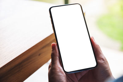 Cropped hands using mobile phone