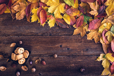 Close-up of cookies and autumn leaves on table