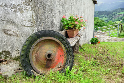 Old rusty flower pot on field