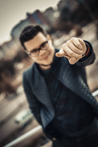Portrait of young man standing outdoors