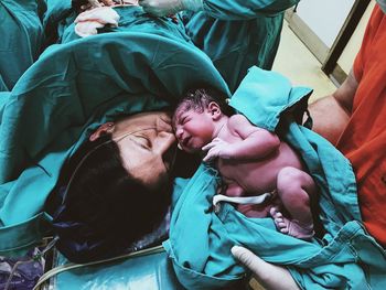 Mother kissing son in hospital ward