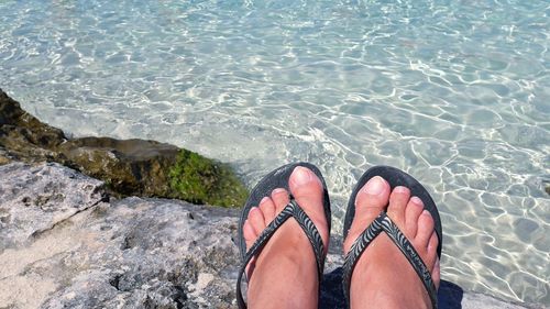 Low section of woman against sea