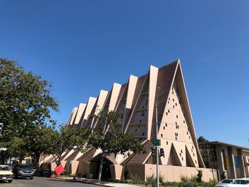 Low angle view of buildings against clear blue sky