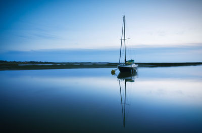 Boat moored in lake against sky