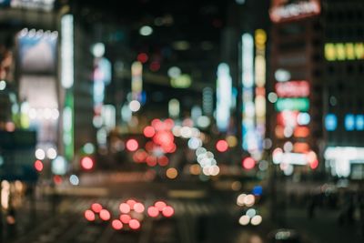 Defocused image of illuminated city street at night