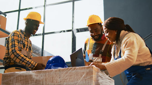 Rear view of people working at construction site