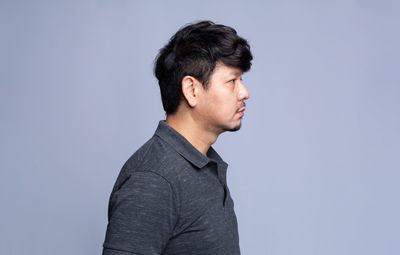 Portrait of mid adult man against blue background