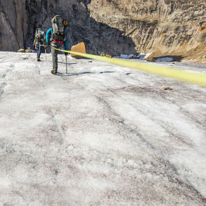 Climbing team on the move, ascending mountain summit.