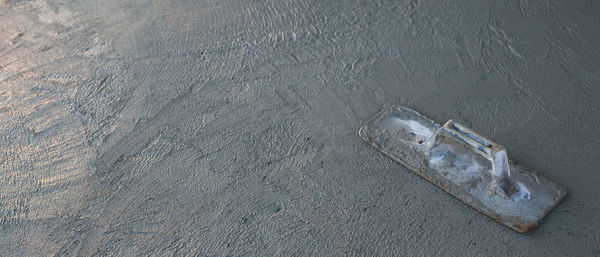 High angle view of footprints on sand at beach